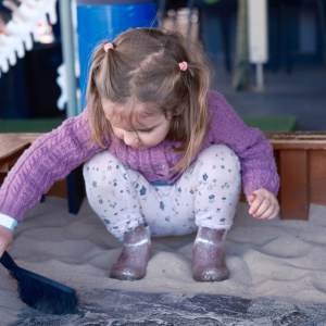 a little girl sitting on a table